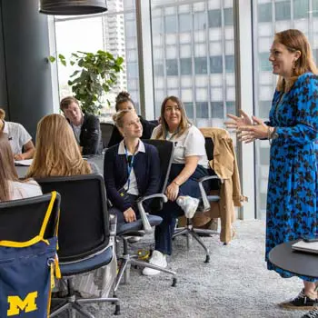 woman talking to people at conference table