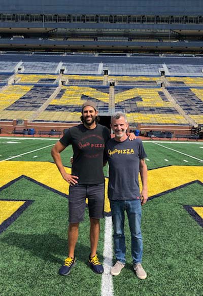 Yasmine Mansi holding up shoes