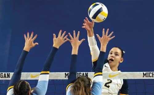 Allison Jacobs holding up shoes