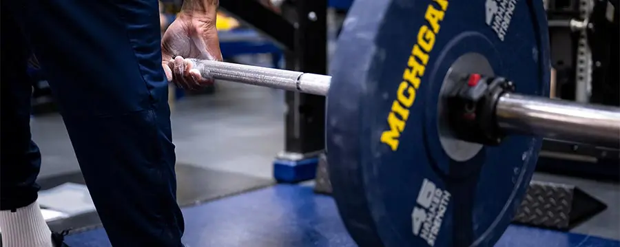 student-athlete lifting weights