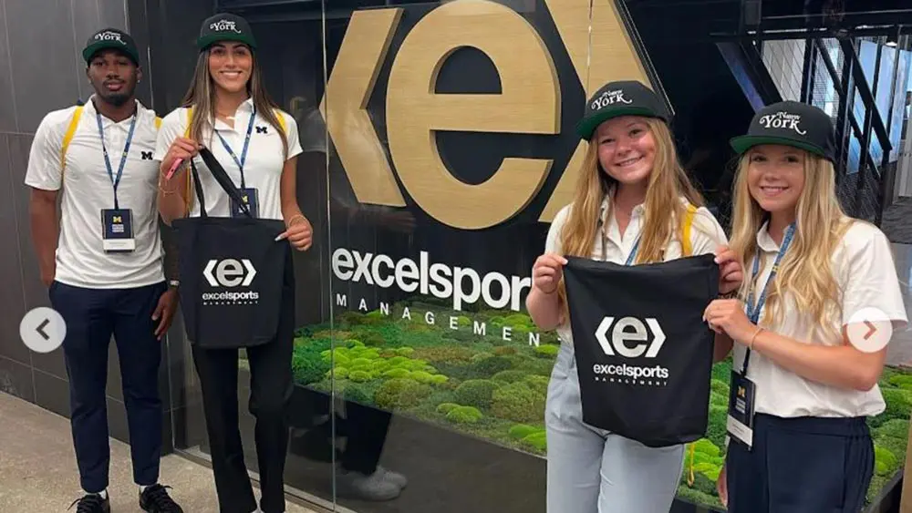 students in front of excelsports sign