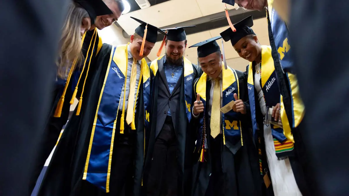 Graduates in a huddle