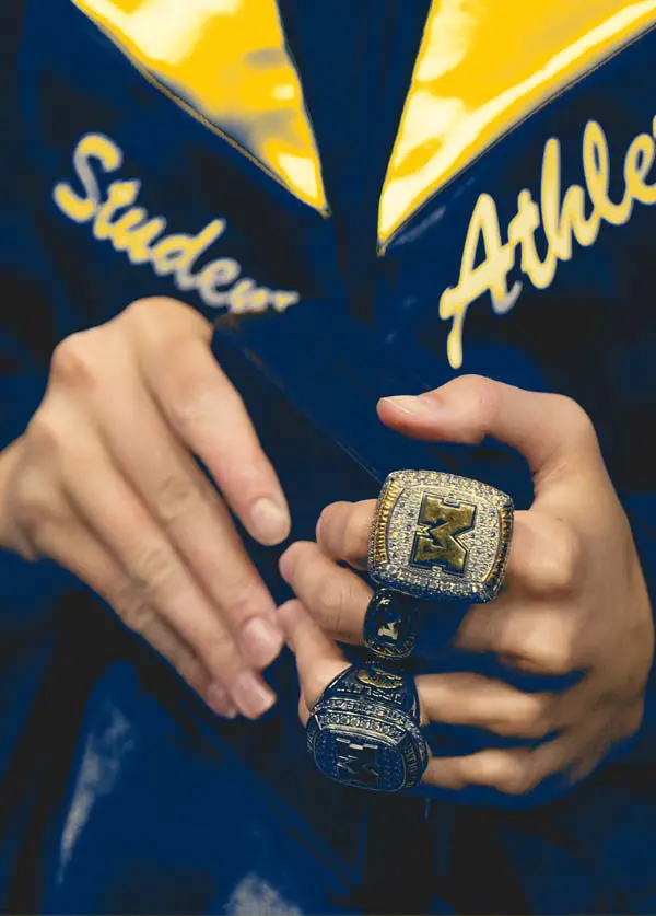 Graduate's hands with rings on